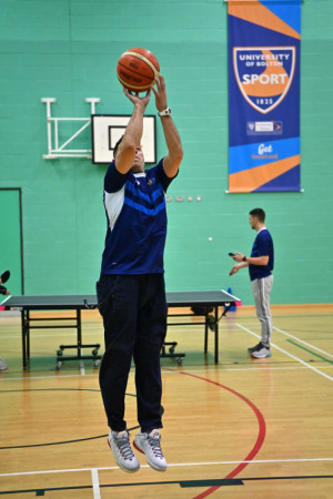 Student throwing basket ball at the university of Bolton 