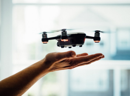 Drone hovering above computer engineers hand
