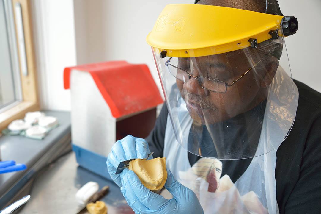 Dental Sciences From the University of Bolton's Centre for Dental Sciences, a person working in the dental laboratory at the Queen's Specialist Building