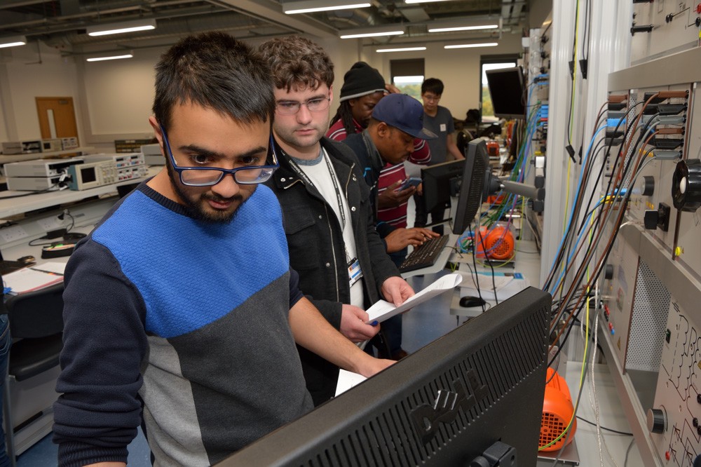 Electrical and electronics engineering students working on test rig